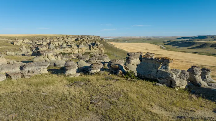 A closer look at the remarkable rock spires and caprock formations lining Buckley Coulee near Sunburst, Montana. Sculpted over centuries by wind and water, these sandstone hoodoos stand guard right where the flat prairie plunges down into the valley floor.